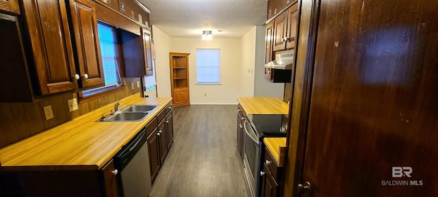 kitchen with sink, stainless steel appliances, butcher block counters, and a textured ceiling