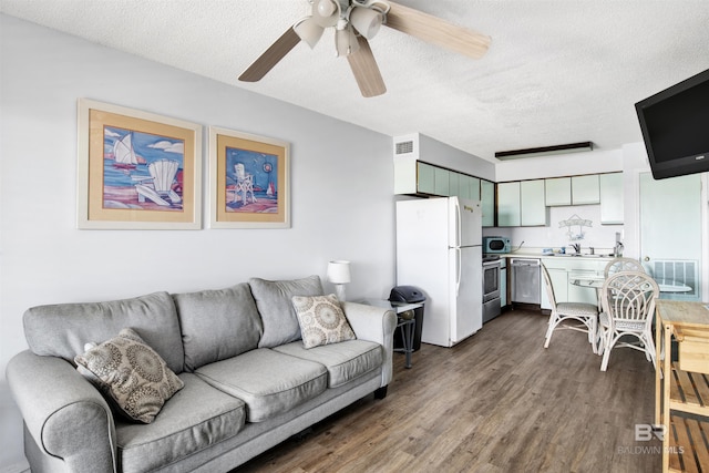 living area with visible vents, dark wood finished floors, a textured ceiling, and ceiling fan