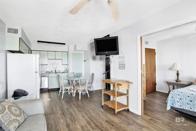 living area featuring a ceiling fan, visible vents, baseboards, and wood finished floors