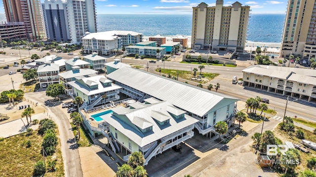 birds eye view of property with a water view and a city view