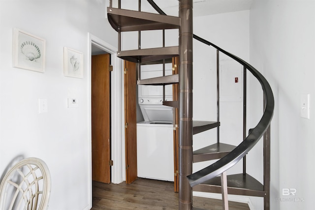 stairway with stacked washer / dryer and wood finished floors