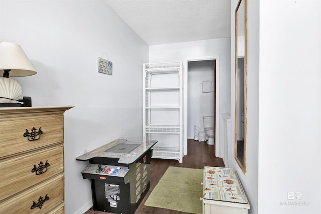 office space with dark wood-style floors, baseboards, and a textured ceiling