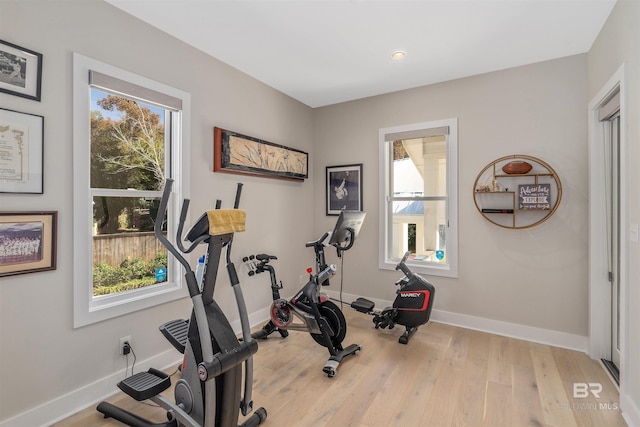 exercise area with light hardwood / wood-style floors