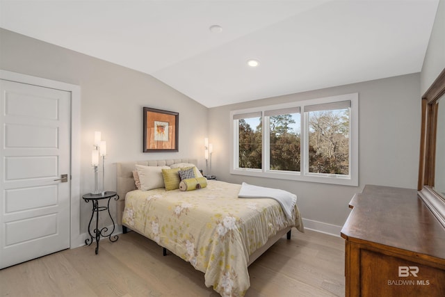 bedroom featuring vaulted ceiling and light wood-type flooring