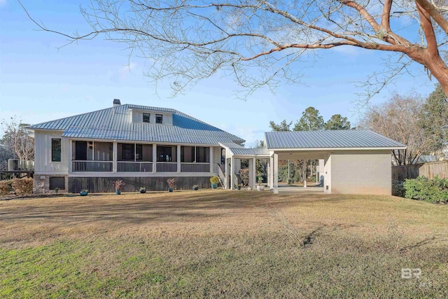 view of front facade featuring a sunroom and a front lawn