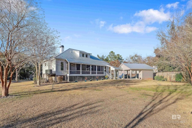 view of front of property with a front yard and a sunroom