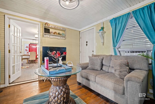 living room with hardwood / wood-style floors, cooling unit, and wood walls