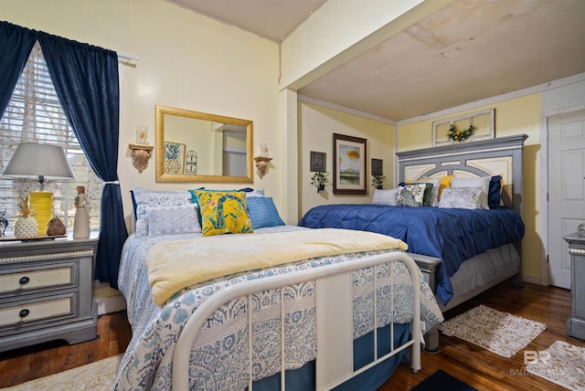 bedroom featuring crown molding and dark hardwood / wood-style flooring