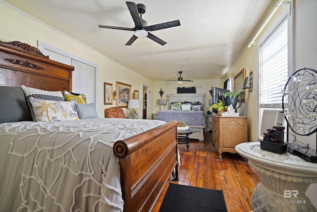 bedroom featuring dark hardwood / wood-style flooring, ceiling fan, and ornamental molding