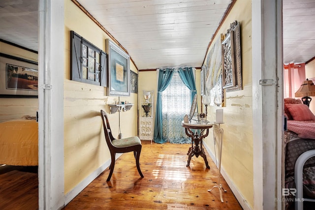 corridor with wood ceiling, crown molding, and wood-type flooring