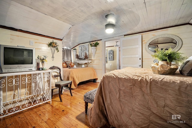 bedroom with wood-type flooring, ornamental molding, wooden walls, and wood ceiling