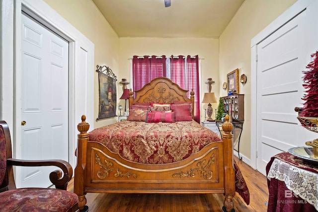 bedroom with dark hardwood / wood-style floors