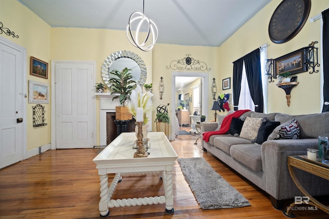 living room featuring wood-type flooring and a notable chandelier