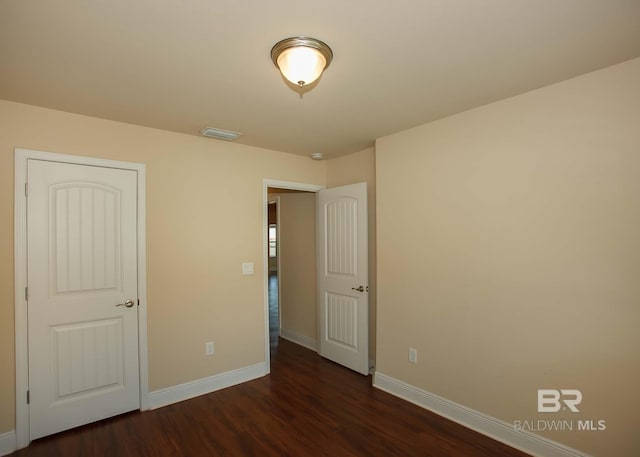 unfurnished bedroom with wood-type flooring