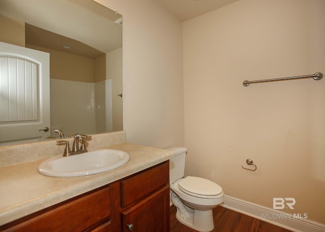 bathroom featuring vanity, hardwood / wood-style floors, and toilet