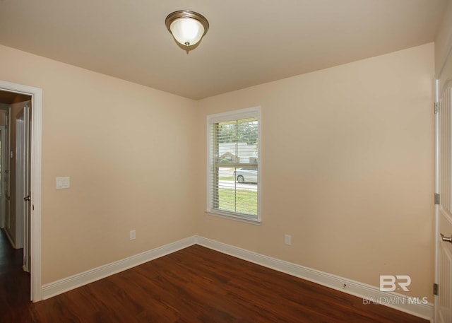 empty room featuring dark hardwood / wood-style flooring