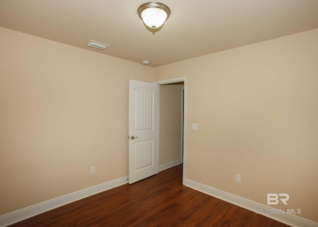 spare room with hardwood / wood-style floors