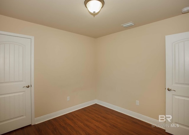 empty room featuring dark wood-type flooring