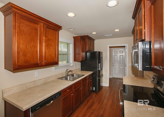 kitchen with sink, stainless steel appliances, and dark hardwood / wood-style floors