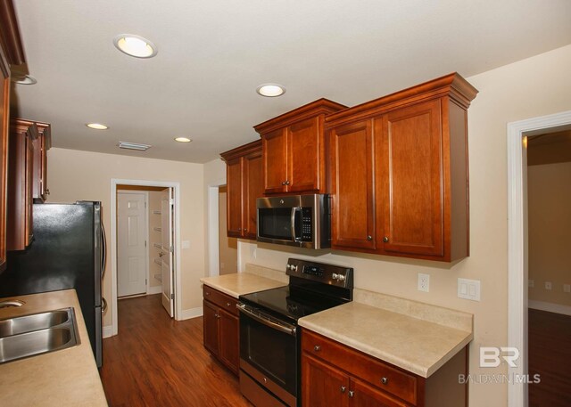 kitchen featuring sink, dark wood-type flooring, and electric range oven