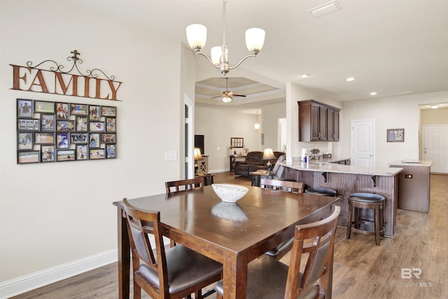dining room featuring visible vents, baseboards, light wood-type flooring, recessed lighting, and ceiling fan with notable chandelier