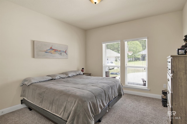 bedroom featuring baseboards and carpet flooring
