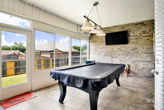 rec room featuring a healthy amount of sunlight, pool table, and brick wall
