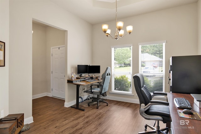 office featuring an inviting chandelier, baseboards, and wood finished floors
