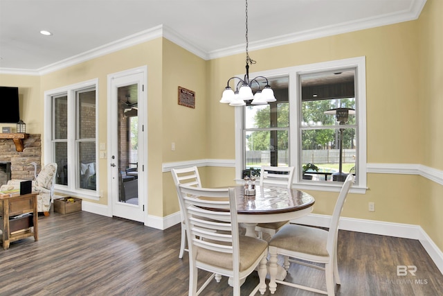 5698 Spring Landing Dr, Theodore, AL 36582 - dining space with a chandelier, dark wood-type flooring, ornamental molding, and a fireplace