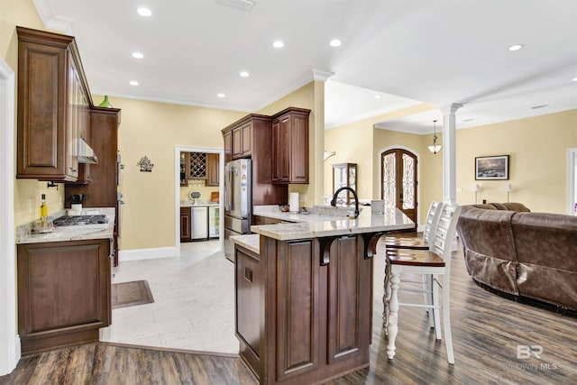 5698 Spring Landing Dr, Theodore, AL 36582 - kitchen with open floor plan, a peninsula, a breakfast bar, appliances with stainless steel finishes, and recessed lighting
