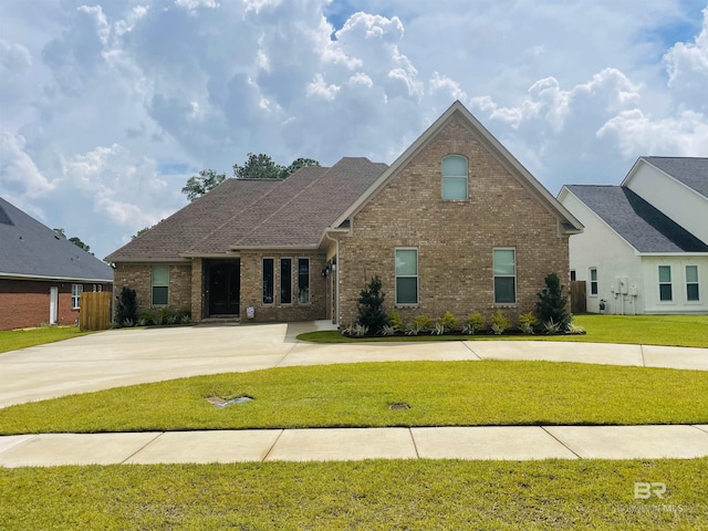 5698 Spring Landing Dr, Theodore, AL 36582 - view of front of property with brick siding, a front lawn, and a shingled roof