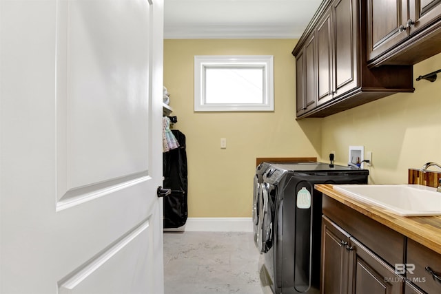 5698 Spring Landing Dr, Theodore, AL 36582 - laundry room featuring independent washer and dryer, cabinet space, and crown molding