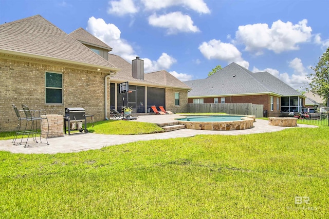 5698 Spring Landing Dr, Theodore, AL 36582 - rear view of house with a sunroom, a patio, brick siding, a fenced backyard, and roof with shingles