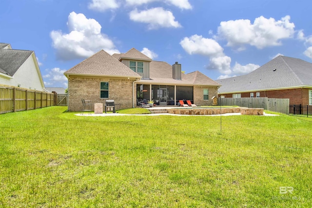 5698 Spring Landing Dr, Theodore, AL 36582 - back of house featuring brick siding, a fenced backyard, a chimney, and a sunroom