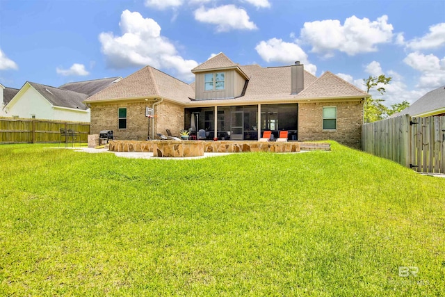 5698 Spring Landing Dr, Theodore, AL 36582 - rear view of property featuring brick siding, a fenced backyard, a sunroom, and a patio area