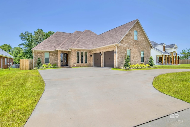 5698 Spring Landing Dr, Theodore, AL 36582 - french country inspired facade featuring brick siding, an attached garage, concrete driveway, and a shingled roof