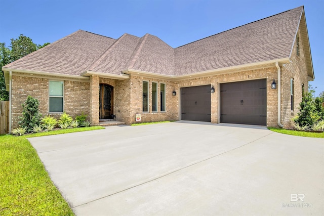 5698 Spring Landing Dr, Theodore, AL 36582 - view of front of property with a shingled roof, brick siding, and an attached garage