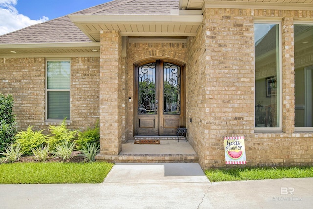 5698 Spring Landing Dr, Theodore, AL 36582 - entrance to property featuring roof with shingles, brick siding, and french doors