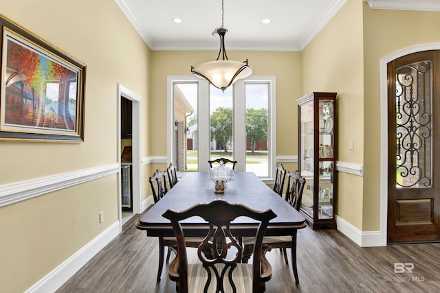 5698 Spring Landing Dr, Theodore, AL 36582 - dining space with dark wood-style flooring, crown molding, recessed lighting, and arched walkways