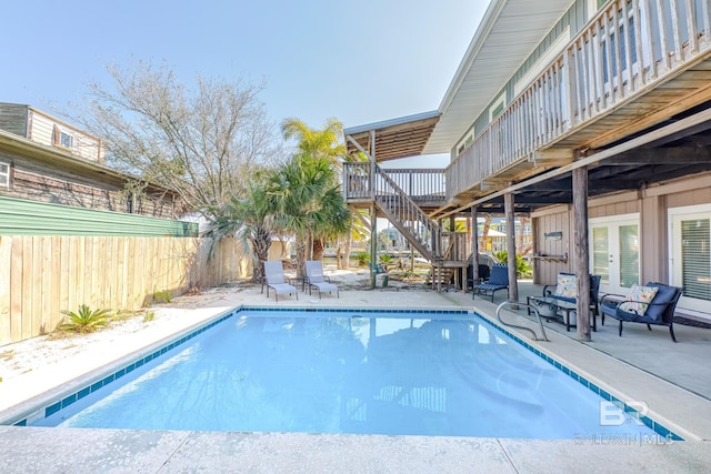 684 Chickasaw Rd, Gulf Shores, AL 36542 - view of swimming pool featuring french doors, a fenced backyard, stairs, a patio area, and a deck