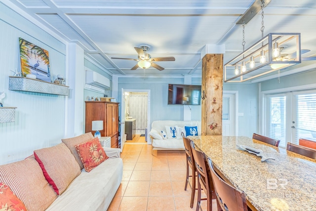 684 Chickasaw Rd, Gulf Shores, AL 36542 - living area featuring a wall mounted AC, light tile patterned floors, and a ceiling fan