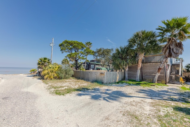 684 Chickasaw Rd, Gulf Shores, AL 36542 - view of asphalt road with stairway and a water view