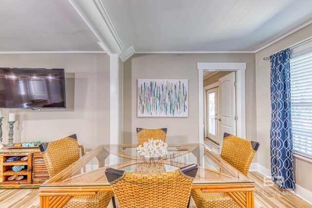 684 Chickasaw Rd, Gulf Shores, AL 36542 - dining room featuring light wood-type flooring and crown molding