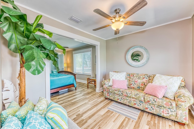 684 Chickasaw Rd, Gulf Shores, AL 36542 - living room with wood finished floors, ceiling fan, and crown molding