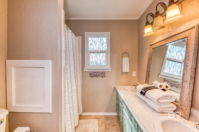 684 Chickasaw Rd, Gulf Shores, AL 36542 - bathroom with plenty of natural light, double vanity, and ornamental molding