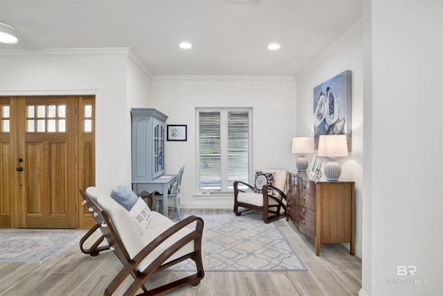 foyer with light wood-style floors, ornamental molding, baseboards, and recessed lighting
