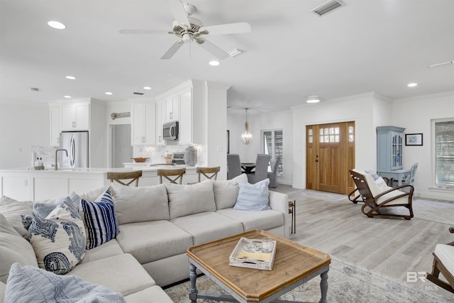 living area featuring recessed lighting, ceiling fan, visible vents, and light wood-style flooring