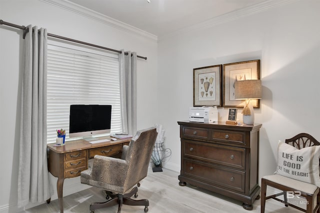 office area with baseboards, ornamental molding, and light wood-type flooring