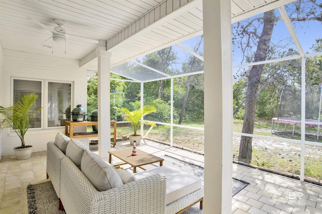 view of patio with a ceiling fan, a trampoline, and a lanai