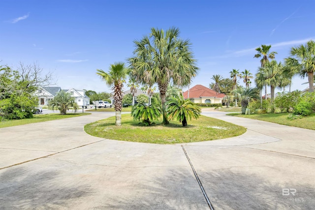 view of front of property with a residential view and concrete driveway